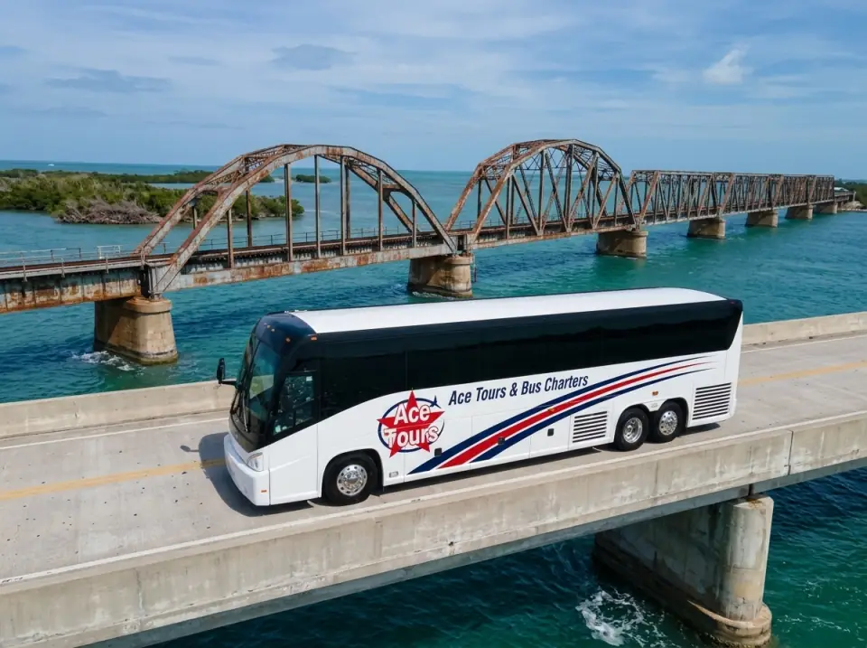 Illustration of a white Ace Tours & Bus Charters motorcoach on the highway bridge at Bahia Honda in the Florida Keys, the old arched rail bridge alongside over turquoise water, seen from a low drone angle