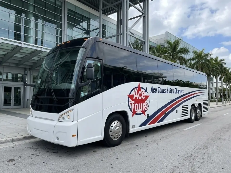 Illustration of a white Ace Tours & Bus Charters motorcoach parked at the glass entrance of a modern Miami convention center