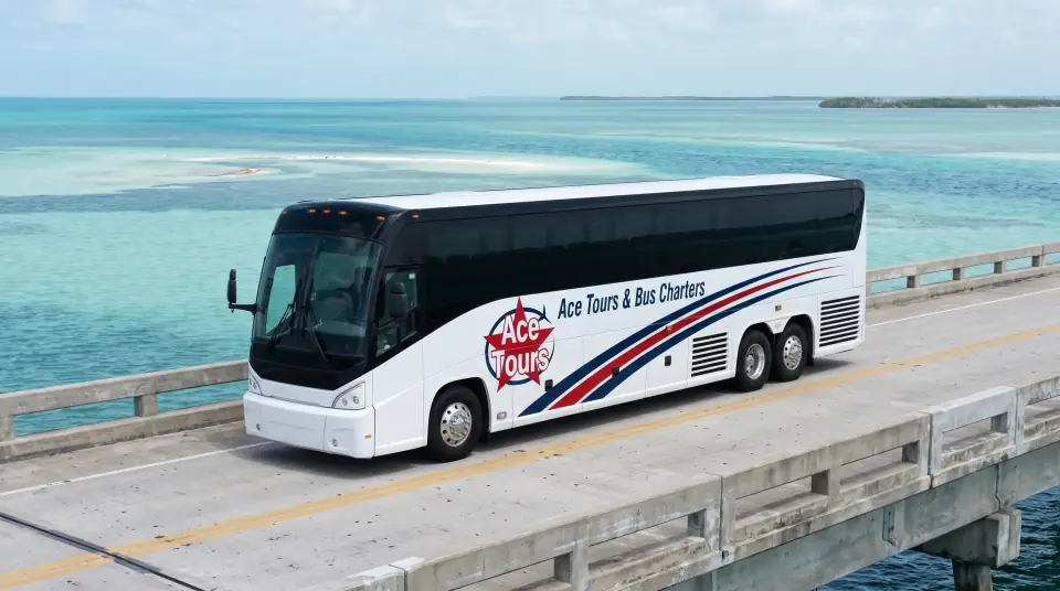 Illustration of a white Ace Tours & Bus Charters motorcoach crossing a long low bridge in the Middle Keys over turquoise water under scattered clouds, front three-quarter view