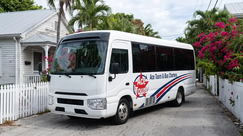 Illustration of a white Ace Tours & Bus Charters minibus on a narrow Key West lane lined with white wooden conch houses, tin roofs, picket fences and bougainvillea