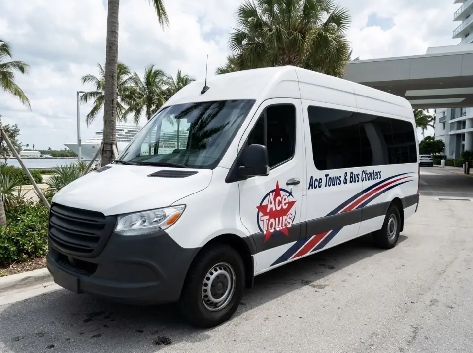 Illustration of a white Ace Tours & Bus Charters Sprinter-style van parked at a Miami Beach hotel entrance with palms